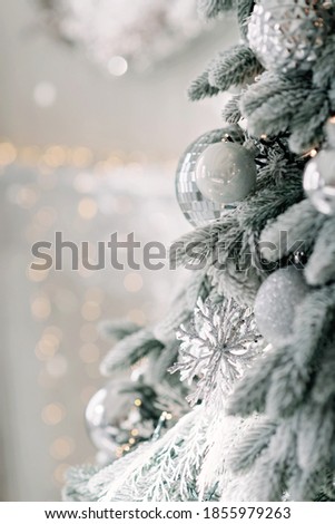 Christmas minimal background, a Christmas tree decorated with balls on a background of blurry bokeh lights. Baner, holiday card, mockup. New Year 2021. Soft selective focus, copy space.