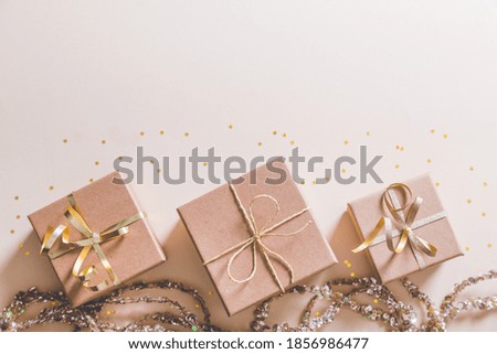 christmas flat lay background in gold color. christmas gifts and golden ribbons