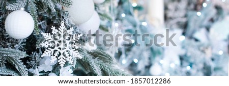 banner. blue christmas decoration, postcard. on the tree a snowflake, balls and a garland.