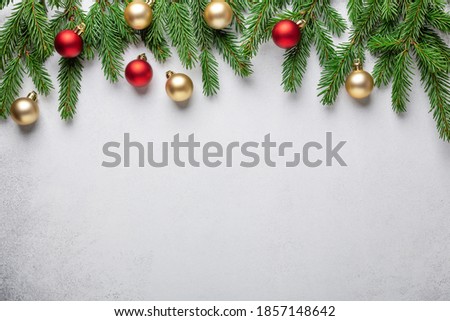 Christmas background. Fir tree branches with red and gold christmas balls on white background. Top view. Copy space - Image
