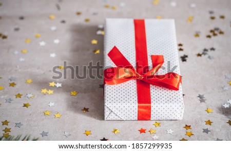 White Christmas present with red ribbon and with copy space