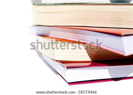 pile of colorful books set against a white background