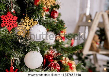 Christmas tree ,Christmas decorations.Colourful baubles hanging from new year tree.winter holidays background.Red, gold, white christmas ornaments,heart, flowers and ball on branches, twinkle lights.