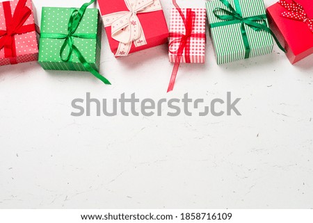 Christmas background with present box and decorations on white. Top view with copy space.