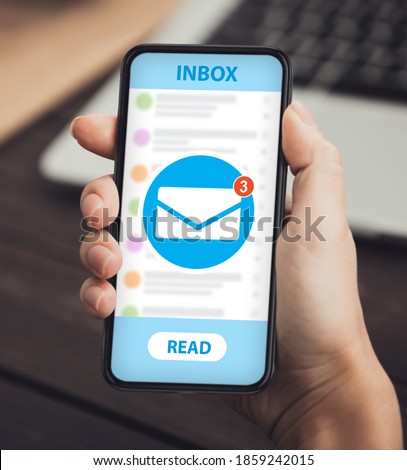 Newsletter and email marketing app for mobile phones. Closeup of female hand holding cellphone with new electronic letter notofication on screen. Woman using mail service for online communication