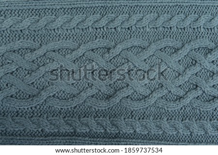 Fabric dark green background.
texture knitted woolen sweater. Abstract knitted fabric background

