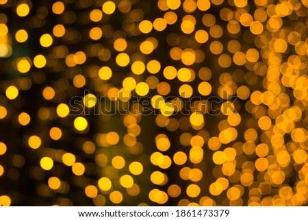 Abstract background with orange and yellow blurred lights with bokeh effect. Festive colors. Christmas celebration concept.