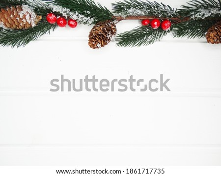 winter christmas background with fir branches cones and snow on white wooden texture                              