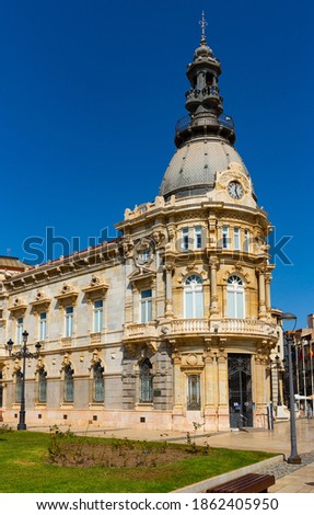 View of impressive circular gallery at corner of building of Cartagena City Hall in eclectic style on sunny day, Spain
