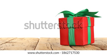 Christmas gift on wooden table against white background. Space for text