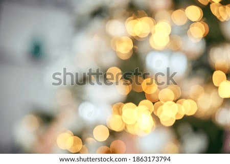 Christmas toys and garlands on the Christmas tree in bokeh, holiday decorations, holiday atmosphere and magic, background for greeting cards