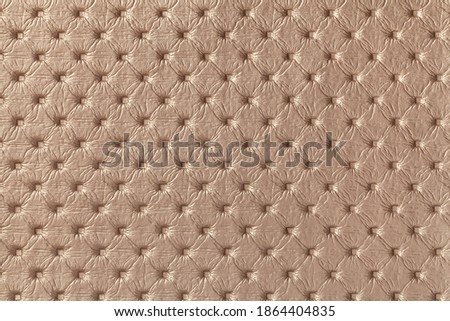 Texture of brown leather background with capitone pattern, macro. Bronze textile of retro Chesterfield style. Vintage fabric backdrop.