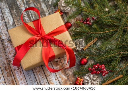 gift box tied with a red ribbon on a Christmas background. Merry Christmas.