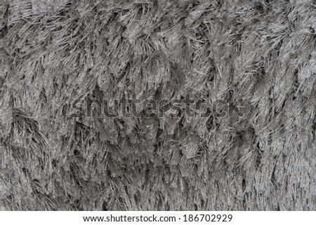 Closeup detail of grey carpet texture background.