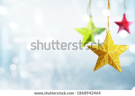 Colorful Christmas star hanging with blurred light background. Merry Christmas