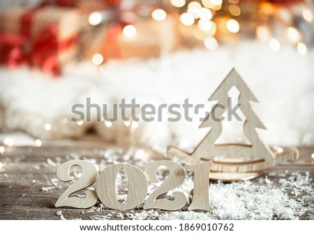 Festive abstract christmas background with wooden number 2021 close up and decor details.