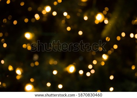 Abstract Christmas yellow lights on tree background.
