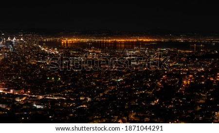 Panorama night view of San Francisco from the Twin Peaks including the lit-up waterfront and piers. 