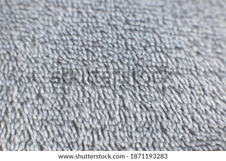 Grey cotton towel or carpet fluffy texture background. Close up photo.