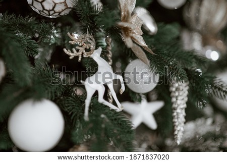 Christmas tree festively decorated with balls and toys