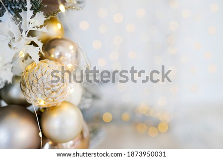 golden Christmas decoration balls and pine cone with bokeh abstract background