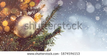 Beautiful bauble hanging on Christmas tree against blurred lights, closeup view with space for text. Banner design