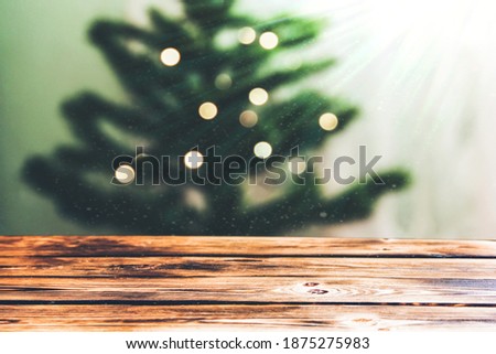 Empty brown wooden background on the background of the Christmas tree. Christmas mood. A place for your creativity