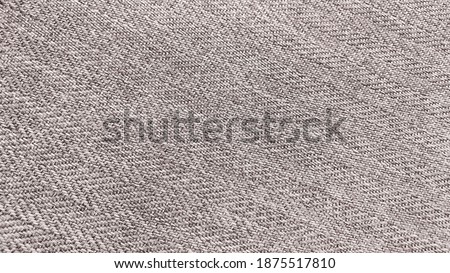 the texture of the herringbone pattern fabric. beige knit fabric with geometric patterns of wool and cotton.