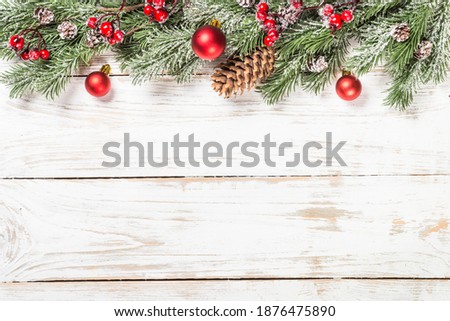 Winter fir tree with red decorations at white table. Top view with copy space.