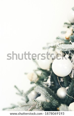  Advertising of goods and services on Christmas and new year's eve. Christmas decorations on the branches of pine needles on a white background with copy space