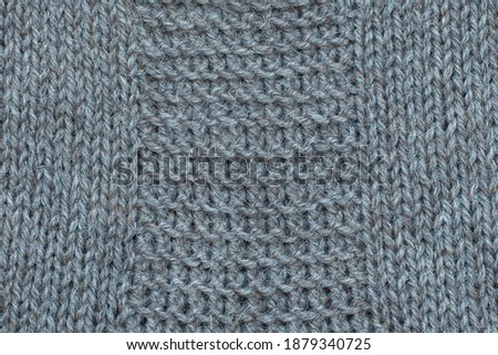 Knitted fabric, hand knit, needle work,  garter stitch and stockinette stitch, clouseup. Virgin wool 