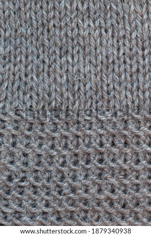 Photo of knitted fabric from virgin wool, hand knit, needle work,  garter stitch and stockinette stitch, clouseup. 