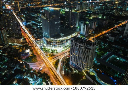Bangkok business district city center above Samyan intersection and traffic, with buildings and skyscrapers, during night - Time Lapse