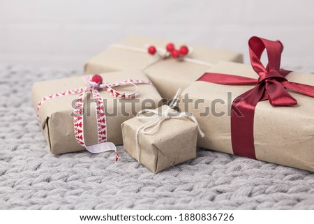 Gift boxes with ribbons on knitted background. Christmas and New Year presents. Birthday greetings and gifts.