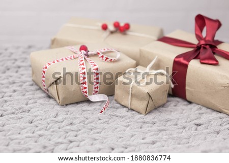 Gift boxes with ribbons on knitted background. Christmas and New Year presents. Birthday greetings and gifts.