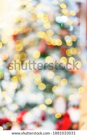 Christmas fairy light on white snow tree. Blurred abstract background.
