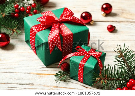 Gift boxes, fir branches and Christmas balls on white wooden table