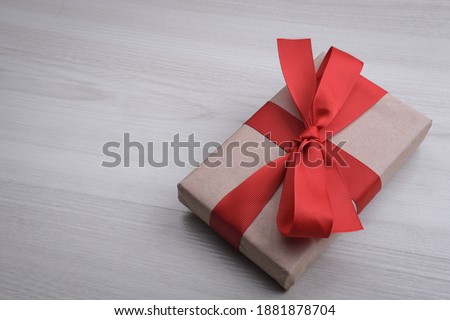 Background for Valentine's Day greeting card.Valentines day concept.Red gift ribbons, gifts, hearts on a wooden background. Top view.