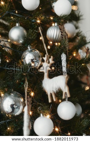 Close up of a decorated Christmas Tree with colourful decorations and garland lights, bokeh. Festive and New Year concept.