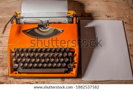 Old retro vintage typewriter with note papers on plain background in top view.  Old retro equipment for journalists, writers and office workers