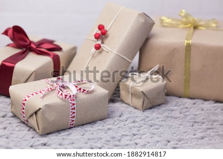 Christmas gift boxes on knitted background. New Year presents.