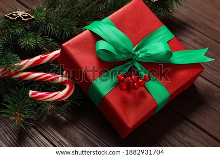 Christmas composition with gift box and festive decor on wooden table