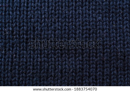 Wool hand knit pattern. Colored wool knitting texture background. Knitted wool sweater.