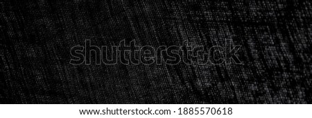 abstract rough dark background of linen natural fabric on the light, short focus