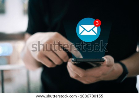 Beautiful hand working on a smartphone with email icons, Concept of sending message wireless using smartphone, copy space for design.