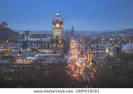 Classic night cityscape view from Calton Hill taking in Princes Street and the Balmoral Clock Tower at Waverley Station in Edinburgh, Scotland.