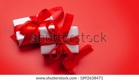 Valentines day gift boxes on red background. With copy space