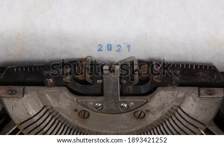 old typewriter with white sheet, lettering 2021