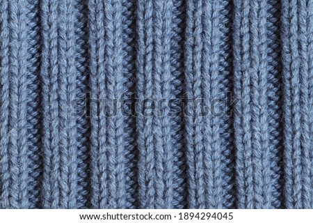 Texture of blue knitted sweater fabric.