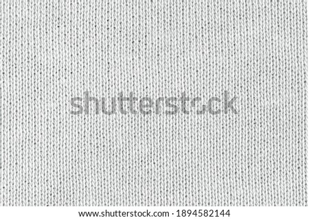White natural texture of knitted wool textile material background. White cotton fabric woven canvas texture